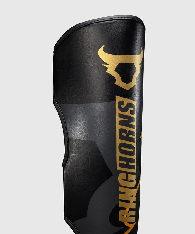 Espinilleras Ringhorns Charger – Negro/Oro
