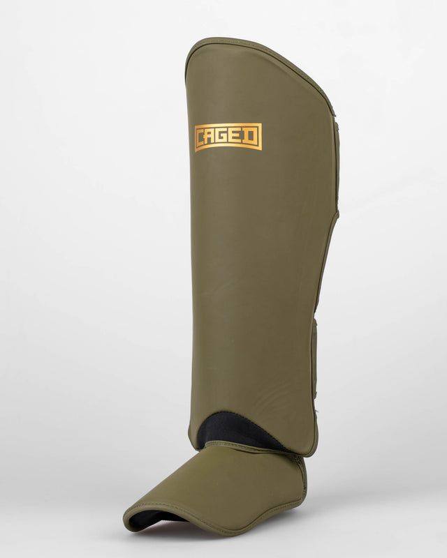 Ochraniacze na piszczele Caged Shadow – Khaki/Złoto